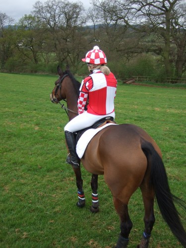 Laura-Paige Millard in a red and white RS2000 with shoulder pads and checked silk cap and checked sleeved ladies event shirt.