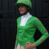 Light green ladies event shirt with cerise stars on sleeves, light green with cerise multi stars cap and pom.