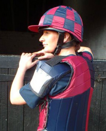Sophie Talbot in a maroon and dark blue Racesafe with shoulder pads and checked silk cap