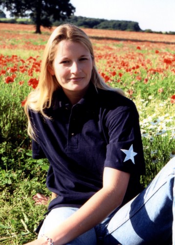 Sophie in a unisex cut dark blue shirt with embroidered white star.